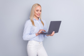 Photo of positive cheerful confident smart girl use laptop read company development information have online communication wear good look trousers isolated over gray color background