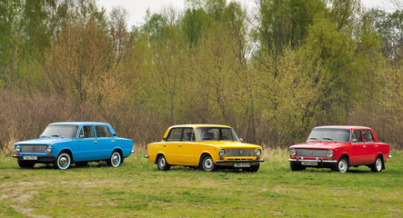 KIEV, UKRAINE-JULY 4, 2016: three retro cars VAZ-2101 "Zhiguli" parked on the green lawn of the forest at Old Car Fest show, JULY 4, 2016 in Kiev, Ukraine. Retro vehicles. Vintage classic cars.