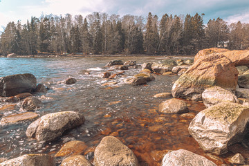 Scandinavian seascape. Waves and rocky coast. Finland. March 2020. Stylized photographs.