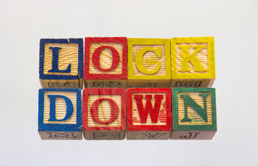 The term lockdown isolated on a clear background using colored wooden toy blocks image in...