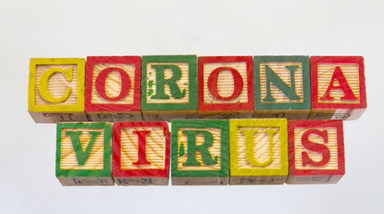 The term coronavirus isolated on a clear background using colored wooden toy blocks image in horizontal format with copy space