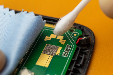Cleaning a mobile phone with a brush and microfiber
