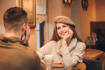 Happy young couple on romantic date in cafe