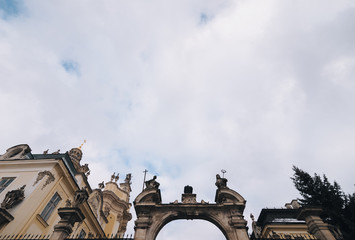 The gate leading to the cathedral of St. George in Lviv. Sculptures in the form of symbolic figures of the Greek and Roman churches. Baroque religious building.