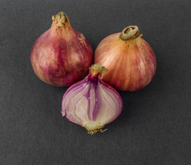 Two and a half medium size fresh and ripe red onion isolated on a white background