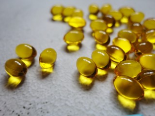 layout of yellow gelatin capsules filled with fish oil-omega 3