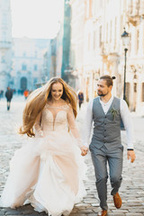 Incredible young couple on the background of the morning city. Lovely bride with long hair....