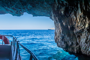 Boat inside the Blue Caves of northern Zakynthos looking at the horizon