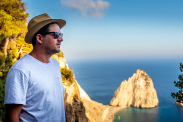 Guy enjoying the view of the Mediterranean coastline in the summer on Zakynthos