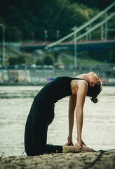 girl doing yoga by the river