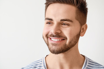 Obraz premium Handsome smiling young man on white background