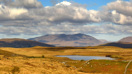 typical Irish landscape from Connemara, Galway Ireland with mountains, clouds and lakes