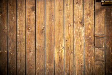  Background in grunge style. Wooden old fence with scuffs. From vertical boards of brown color. With dark vignette around the edges.