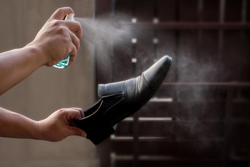 Preventive measures against Covid-19 infection. A man cleans his shoes