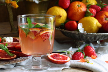 Still life with a cocktail with red oranges