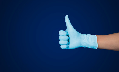 Doctor hand with glove showing like gesture or thumb up as approval, accept or done concept