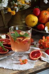 Still life with a cocktail with red oranges