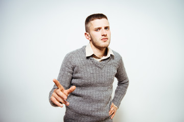Young man showing his index finger towards the camera