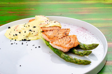 Salmon on asparagus with turmeric and shrimp sauce.