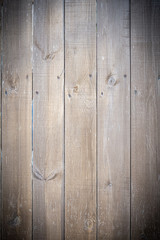  Background in grunge style. Wooden old fence with scuffs. From vertical boards of brown color....