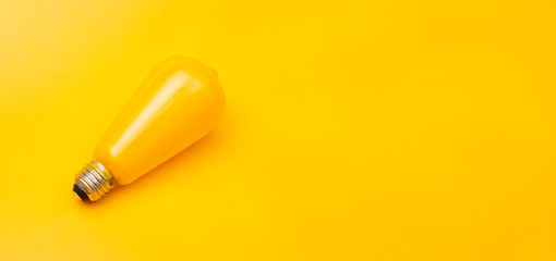 A close up of a yellow bulb idea concept on banner template