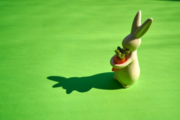 white easter bunny on green paper background
