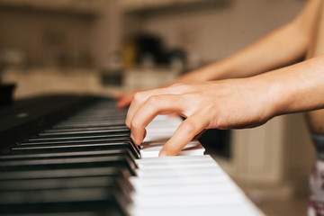 Fototapeta na wymiar Child hands playing piano