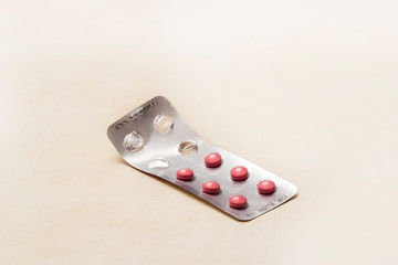 Open pack of pills isolated on white background