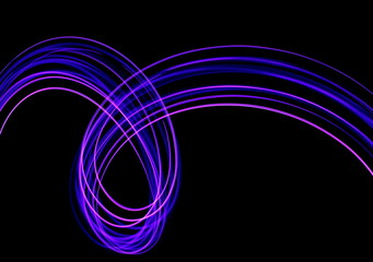 Long exposure photograph of neon purple streaks of light in an abstract swirl, parallel lines pattern against a black background. Light painting photography.