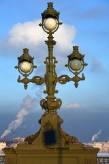Fototapeta na wymiar Old street lamp on Troitsky bridge in Saint-Petersburg, Russia