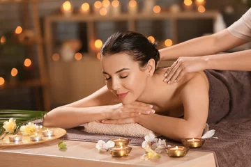Fototapeten Beautiful young woman receiving massage in spa salon © Pixel-Shot
