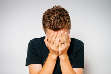 portrait of a man with hands on his head