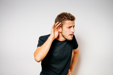 Overhears a man, tries to listen.