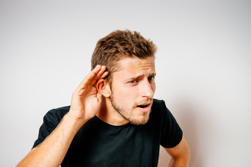 Overhears a man, tries to listen.