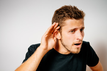 Overhears a man, tries to listen.