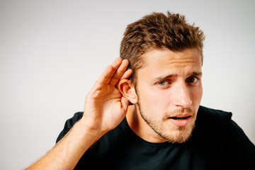 Overhears a man, tries to listen.