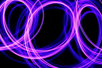 Long exposure photograph of neon purple streaks of light in an abstract swirl, parallel lines pattern against a black background. Light painting photography.
