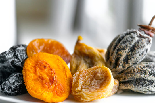 dried fruits lie on a white background, all kinds, rice, dried apricots, peach and grusha