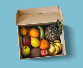 Fresh fruit delivery box on blue background