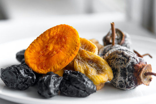 dried fruits lie on a white background, all kinds, rice, dried apricots, peach and grusha
