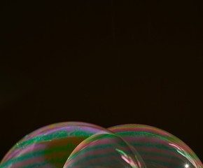 two half soap bubbles superimposed on a black background, Horizontal format
