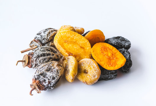 dried fruits lie on a white background, all kinds, rice, dried apricots, peach and grusha.Copy space