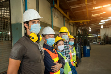Group technician is ready to work at factory and wear a mask to prevent the disease from Coronavirus Disease 2019 (COVID-19).
