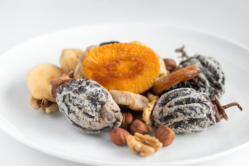 different kinds of nuts and dry fruits in a plate.