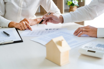 Real Estate Agent broker or House developer showing contract for buying house agreement to...