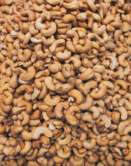 Roasted cashew nuts closeup texture photo.