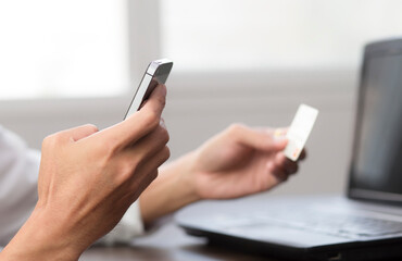 Man using smartphone and hold credit card, Payment online shopping conce