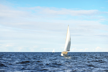Old expensive vintage wooden sailboat (yawl) close-up, sailing in an open sea. Stunning cloudscape. Coast of Maine, US © Alex Stemmer