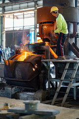 Fototapeta premium Casting, melting, molding and foundry. The most widely used non reusable mold method is sand casting a process in which specially treated sand is rammed around the pattern and placed in a support. 