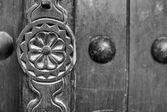 Detail of a carving on a traditional wooden Arabian door.